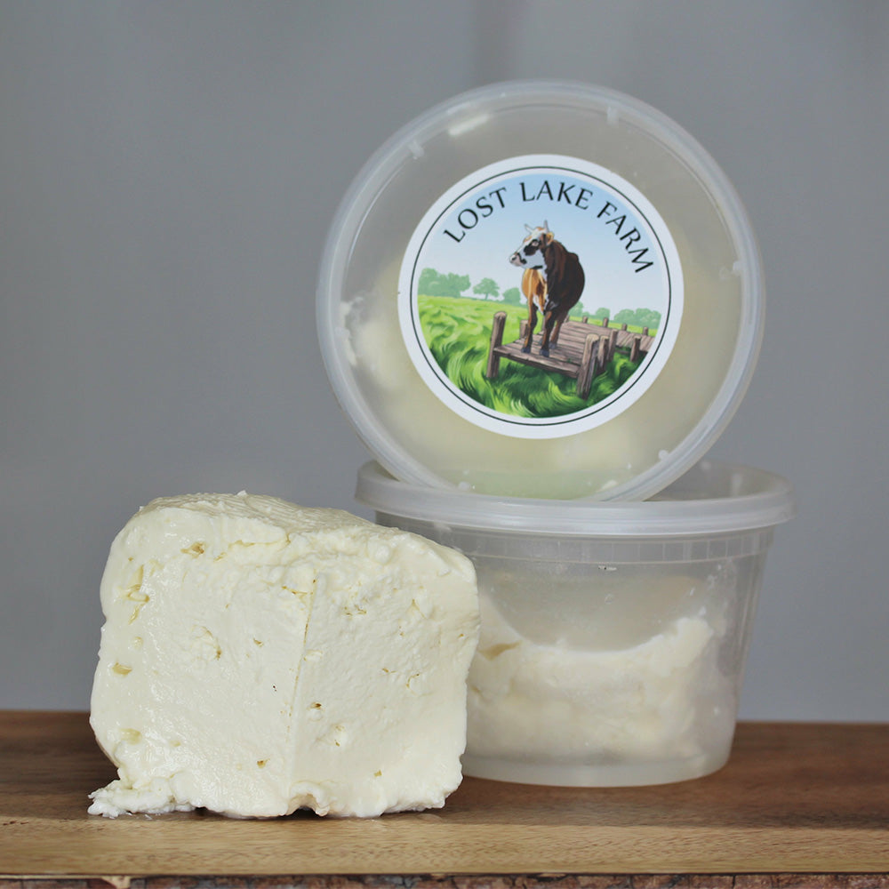 Crumbled artisanal cow's milk feta from Lost Lake Farm sprinkled over a fresh, bright grain bowl with vegetables.