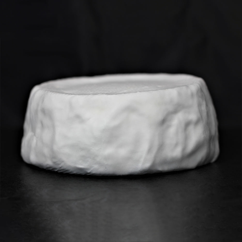 A full, uncut farmstead Camembert wheel of Camembert de Comte de Hamilton, showing its soft, white, bloomy rind.