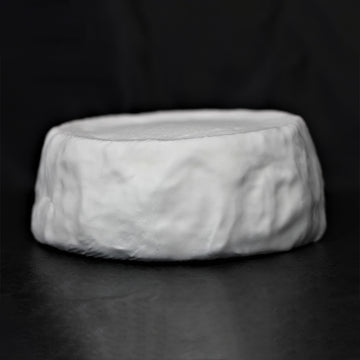 A full, uncut farmstead Camembert wheel of Camembert de Comte de Hamilton, showing its soft, white, bloomy rind.